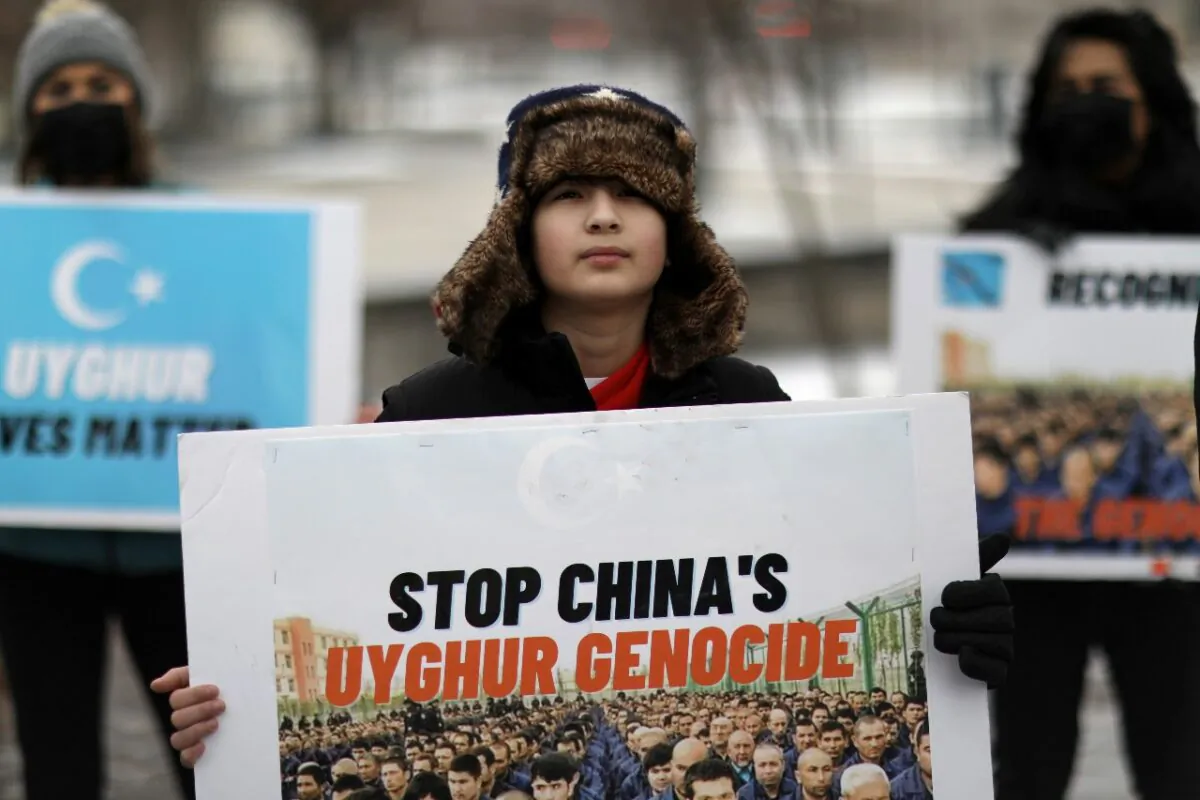 People take part in a rally to encourage Canada and other countries as they consider labeling China's treatment of its Uighur population and Muslim minorities as genocide, outside the Canadian Embassy in Washington on Feb. 19, 2021. (Reuters/Leah Millis)