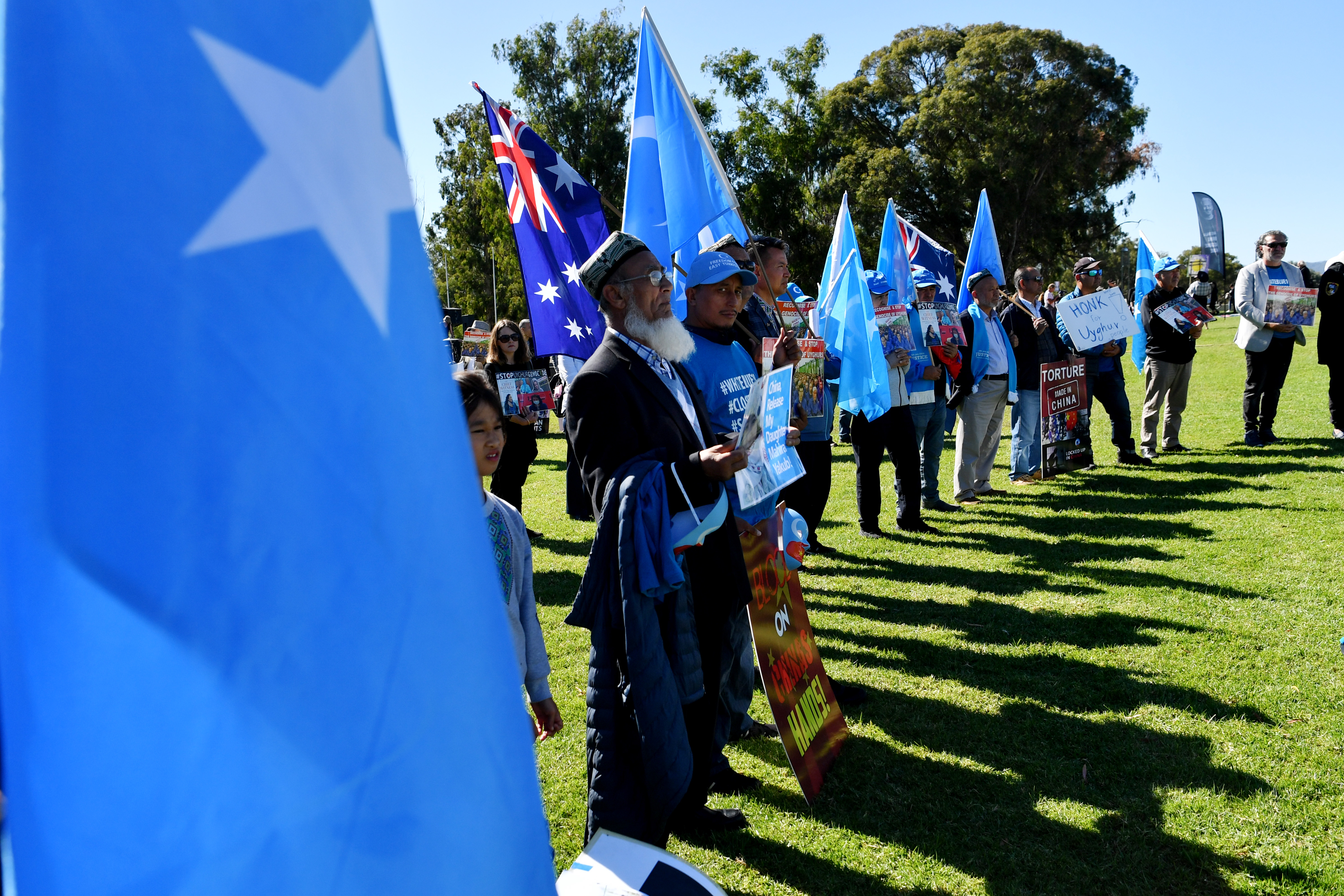 Protestors attend a rally for the Uyghur community