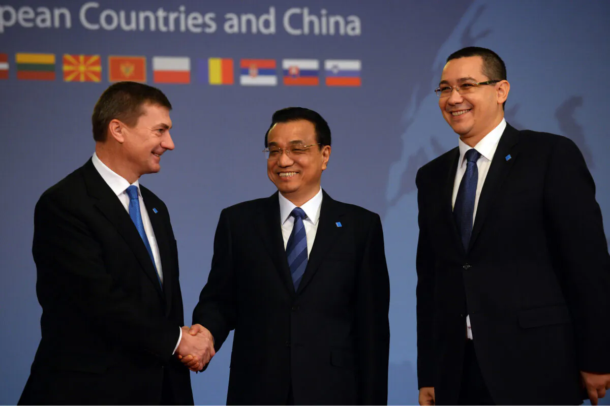 Estonian Prime Minister Andrus Ansip (L) is welcomed by Chinese Prime Minister Li Keqiang (C) and Romanian counterpart Victor Ponta at the beginning of the "Meeting of Heads of Government of Central and Eastern European Countries and China" at the Parliament palace in Bucharest on Nov. 26, 2013. (Daniel Mihailescu/AFP via Getty Images)