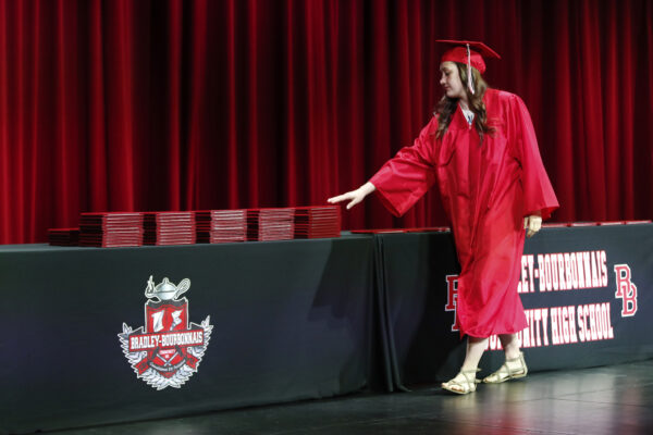 student picks up diploma