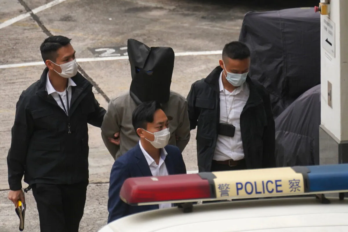 One of the 12 Hong Kong activists who were detained last year in mainland China for an illegal border crossing arrives at Tin Shui Wai police station in Hong Kong, China, on March 22, 2021. (Lam Yik/Reuters)