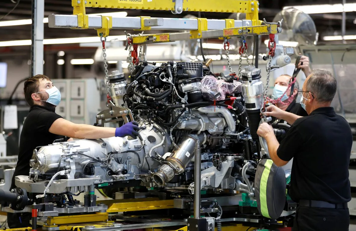 Technicians work on a Rolls-Royce engine prior to it being installed in a car on the production line of the Rolls-Royce Goodwood factory, near Chichester, Britain, on Sept. 1, 2020.  (Peter Nicholls/Reuters)