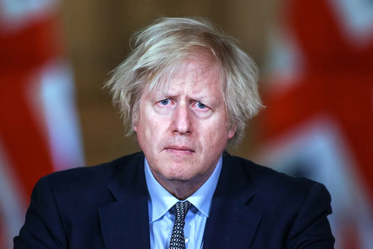 Britain's then-Prime Minister Boris Johnson gives an update on the COVID-19 pandemic during a virtual press conference on the one year anniversary of Britain's first national lockdown inside 10 Downing Street in central London, on March 23, 2021. (Hannah McKay/POOL/AFP via Getty Images)