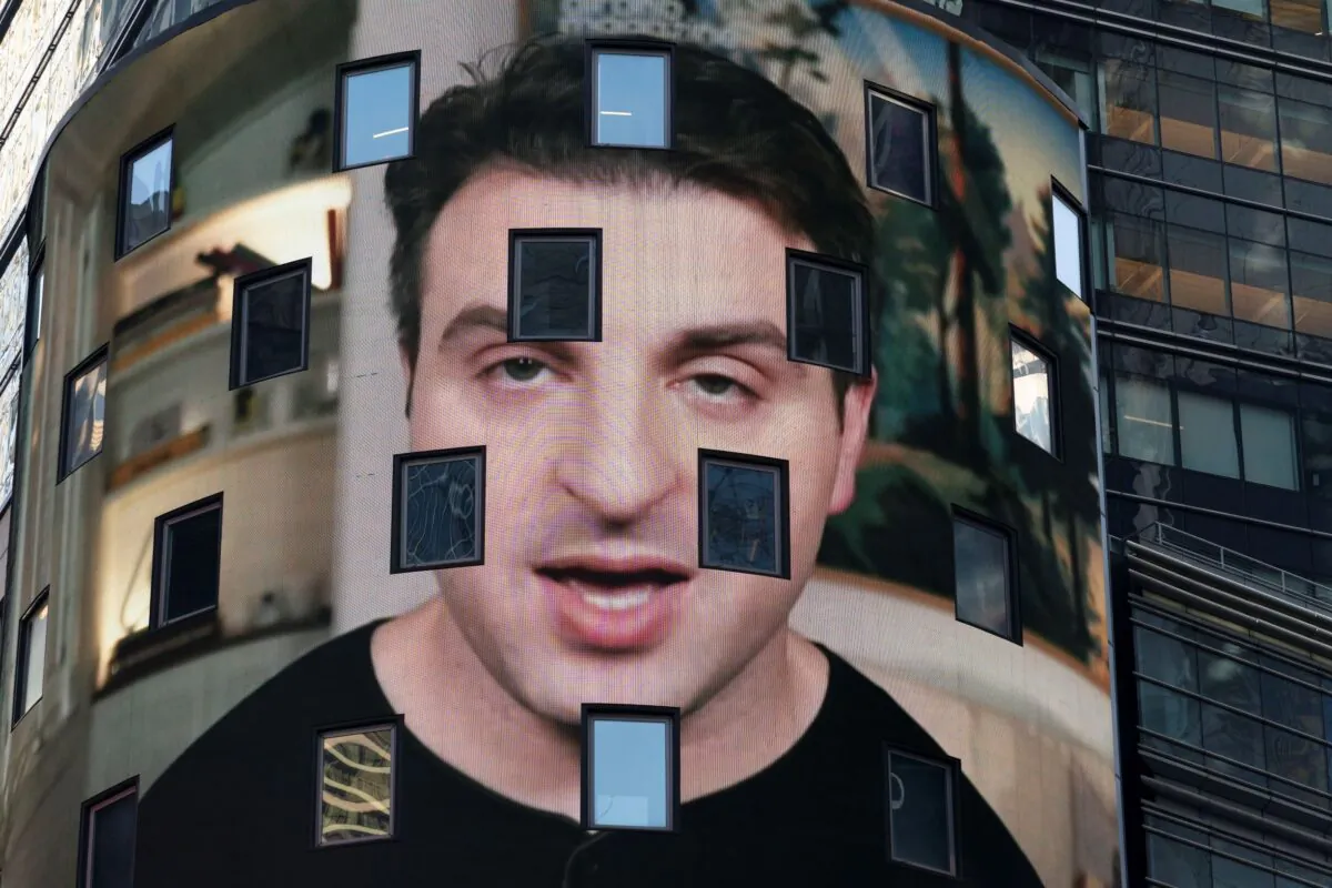 Brian Chesky, CEO of Airbnb, is shown on an electronic screen at the Nasdaq MarketSite in New York City, on Dec. 10, 2020. (Mark Lennihan/AP Photo)