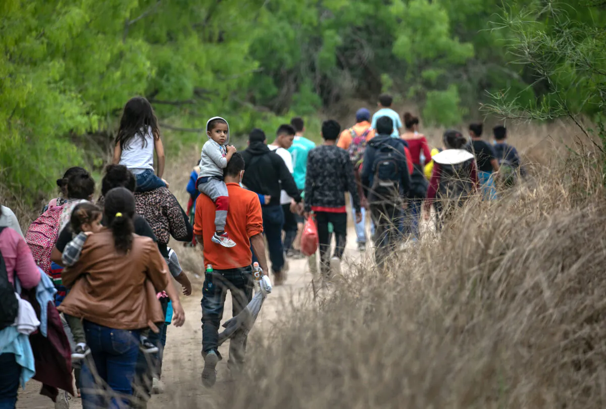 Illegal immigrants, most from Honduras, walk toward a U.S. Border Patrol checkpoint after crossing the Rio Grande from Mexico near Mission, Texas, on March 23, 2021. (John Moore/Getty Images)