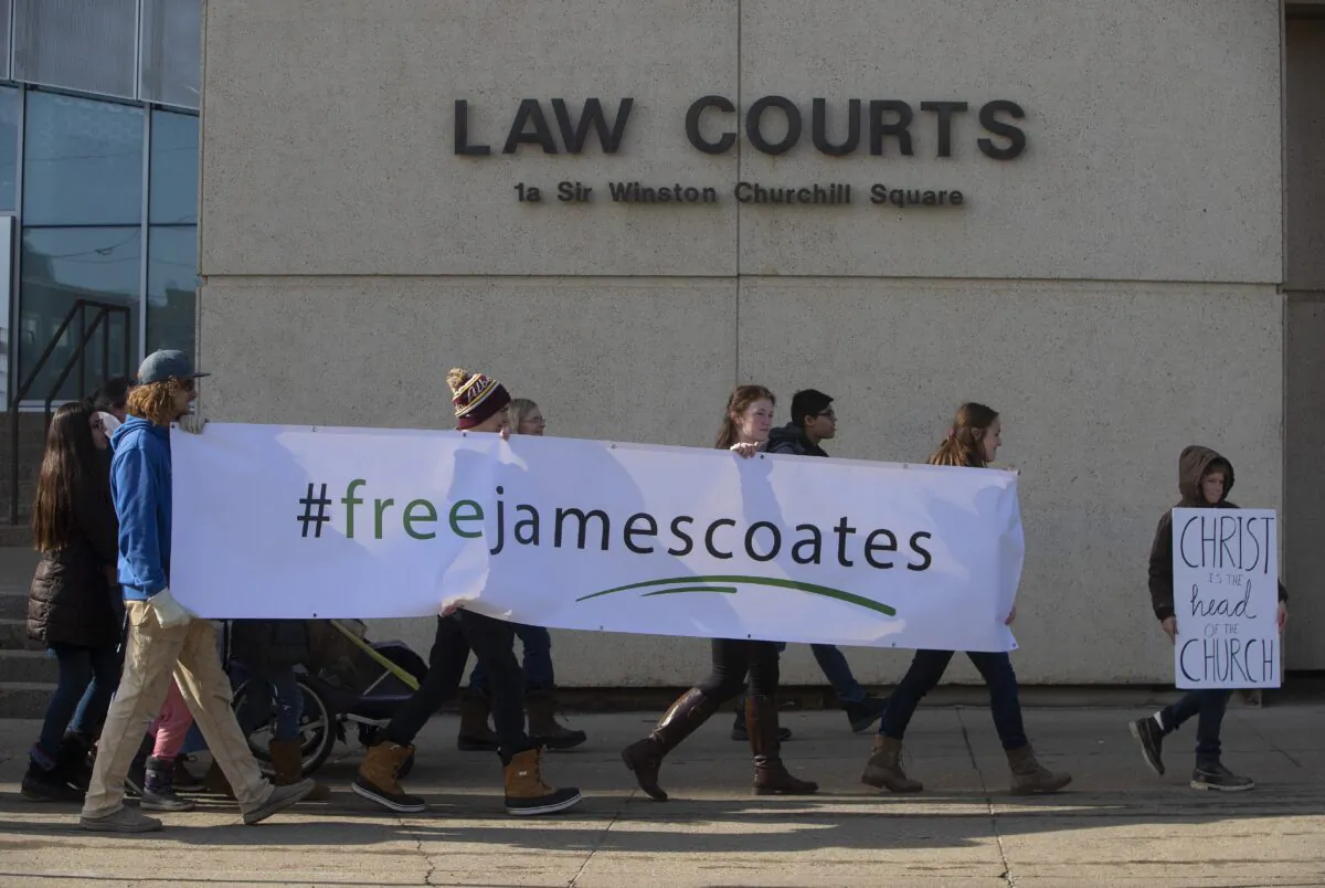 Supporters rally outside court as Pastor James Coates, of GraceLife Church, is in court to appeal the bail conditions, after he was arrested for holding day services in violation of COVID-19 rules in Edmonton, Alta., on March 4, 2021. (Jason Franson/The Canadian Press)