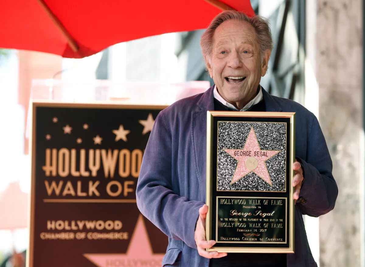 Actor George Segal poses with a replica of his star at a ceremony honoring him on the Hollywood Walk of Fame in Los Angeles, Calif., on Feb. 14, 2017. (Chris Pizzello/Invision/AP Photo)