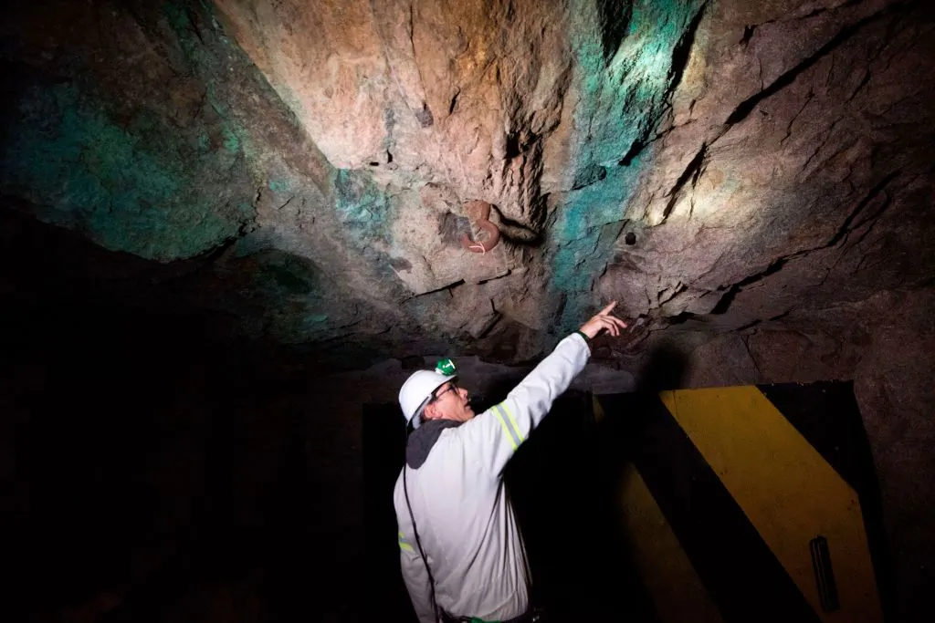 A mine geologist points to where the monazite reef (darker rock) containing rare-earth minerals is at the Steenkampskraal mine, about 50 miles from the Western Cape town of Vanrhynsdorp, South Africa, on July 29, 2019. (Rodger Bosch/AFP via Getty Images)