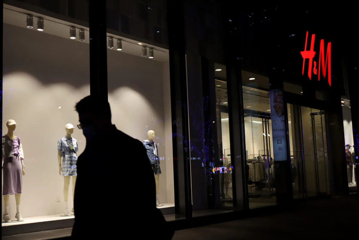 A man walks past a store of the Swedish fashion retailer H&M at a shopping mall in Beijing, China, on March 24, 2021. (Florence Lo/Reuters)