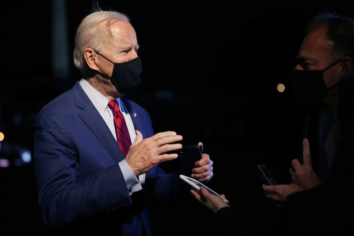 President Joe Biden talks briefly with reporters after arriving back at the White House on March 23, 2021. (Chip Somodevilla/Getty Images)