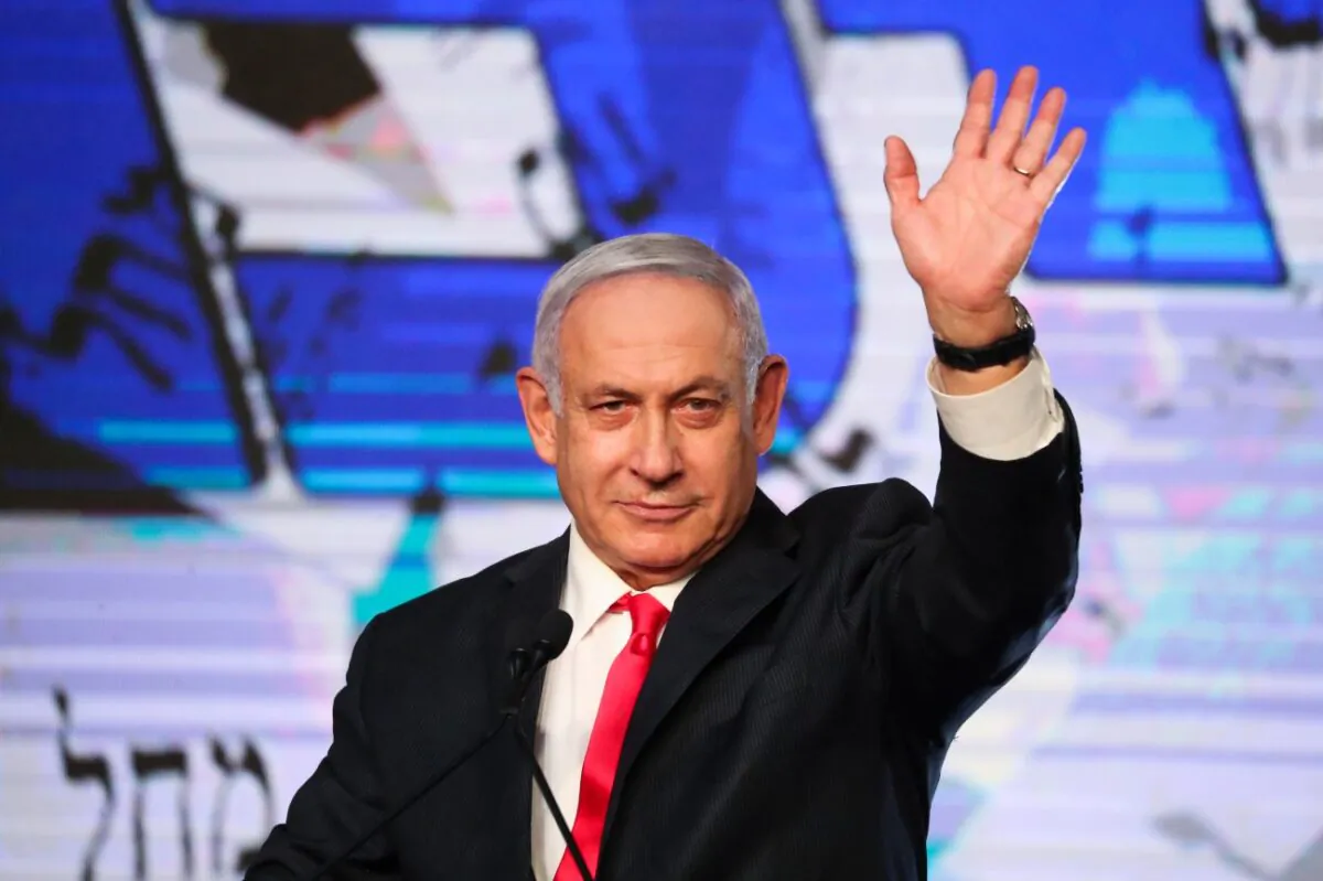 Israeli Prime Minister Benjamin Netanyahu waves to his supporters after the first exit poll results for the Israeli parliamentary elections at his Likud party's headquarters in Jerusalem, on March. 24, 2021. (Ariel Schalit/AP Photo)