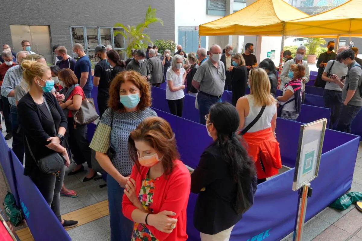 People queue up outside a vaccination center for BioNTech in Hong Kong, on March 24, 2021.(Vincent Yu/AP Photo)