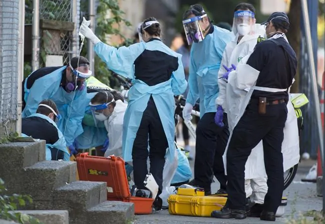 Paramedics perform chest compressions on an individual in Vancouver’s Downtown Eastside on Sept. 10, 2020. (Jonathan Hayward/The Canadian Press)