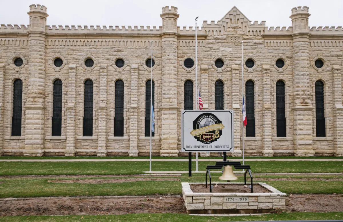Flags are flown at half staff in memory of the two prison workers killed in an escape attempt at the Anamosa State Penitentiary in Anamosa, Iowa, on March 24, 2021. (Jim Slosiarek/The Gazette via AP)