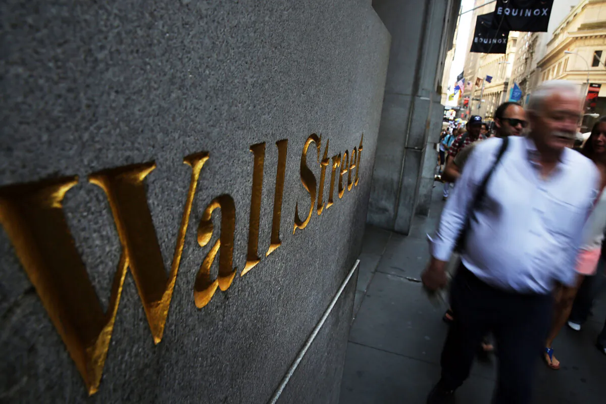 A man walks by the New York Stock Exchange (NYSE) in New York City, on Aug. 24, 2015. (Spencer Platt/Getty Images)