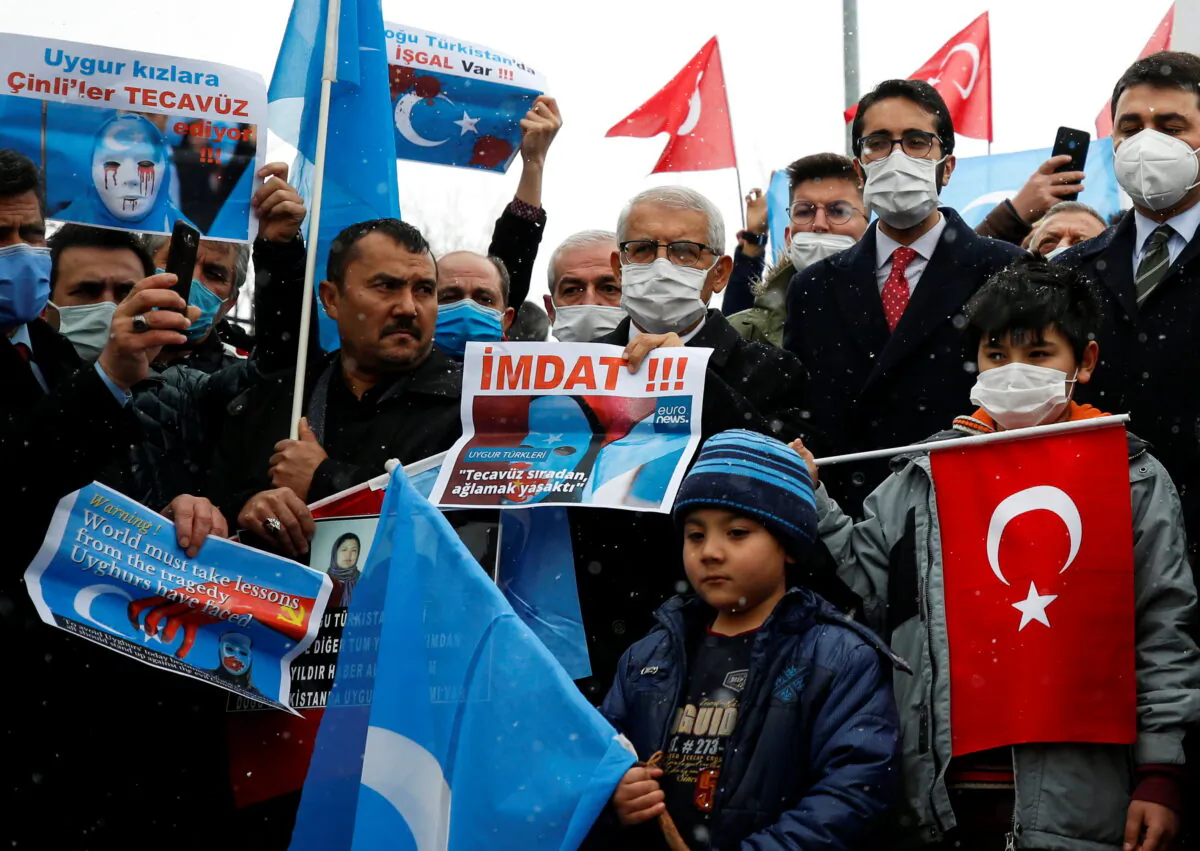 Ethnic Uyghurs and activists attend a protest against the visit of China's State Councilor and Foreign Minister Wang Yi to the Turkish capital in front of the Chinese Embassy in Ankara, Turkey on March 25, 2021. (Cagla Gurdogan/Reuters)