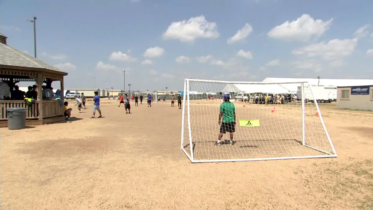 Unaccompanied minors are seen playing soccer at a holding facility in Carrizo Springs, Texas, on March 24, 2021. (Pool)