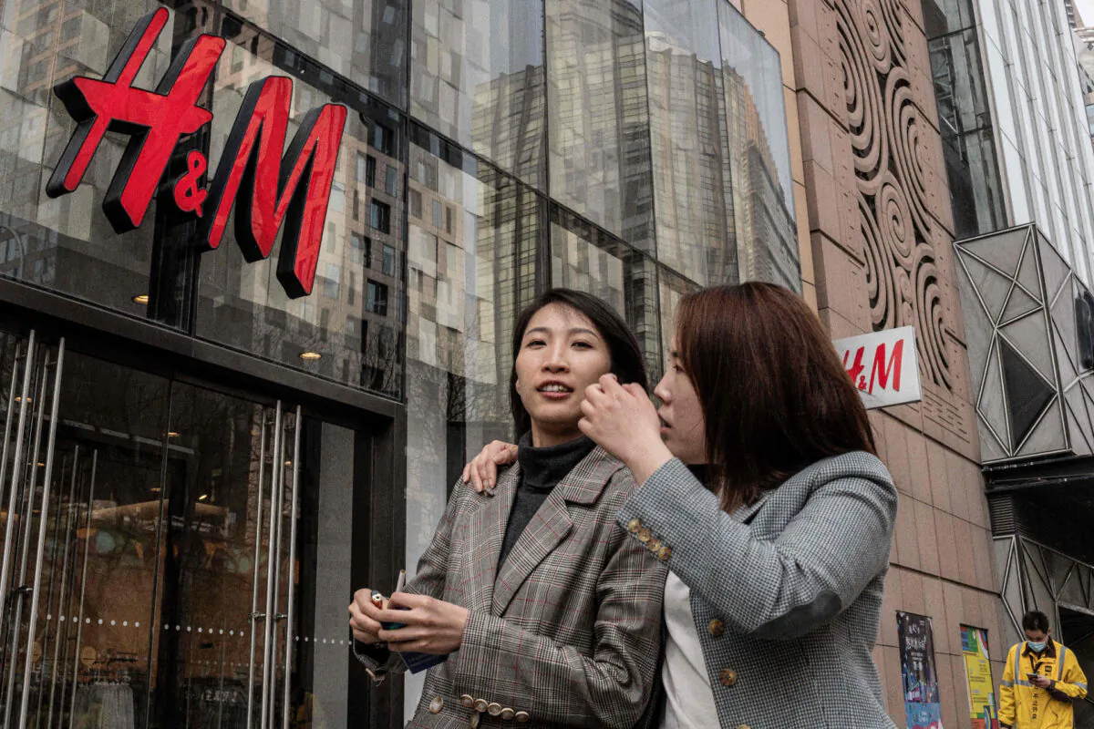 People walk past a store of Swedish clothing company H&M in Beijing on March 25, 2021. (Nicolas Asfouri/AFP via Getty Images)
