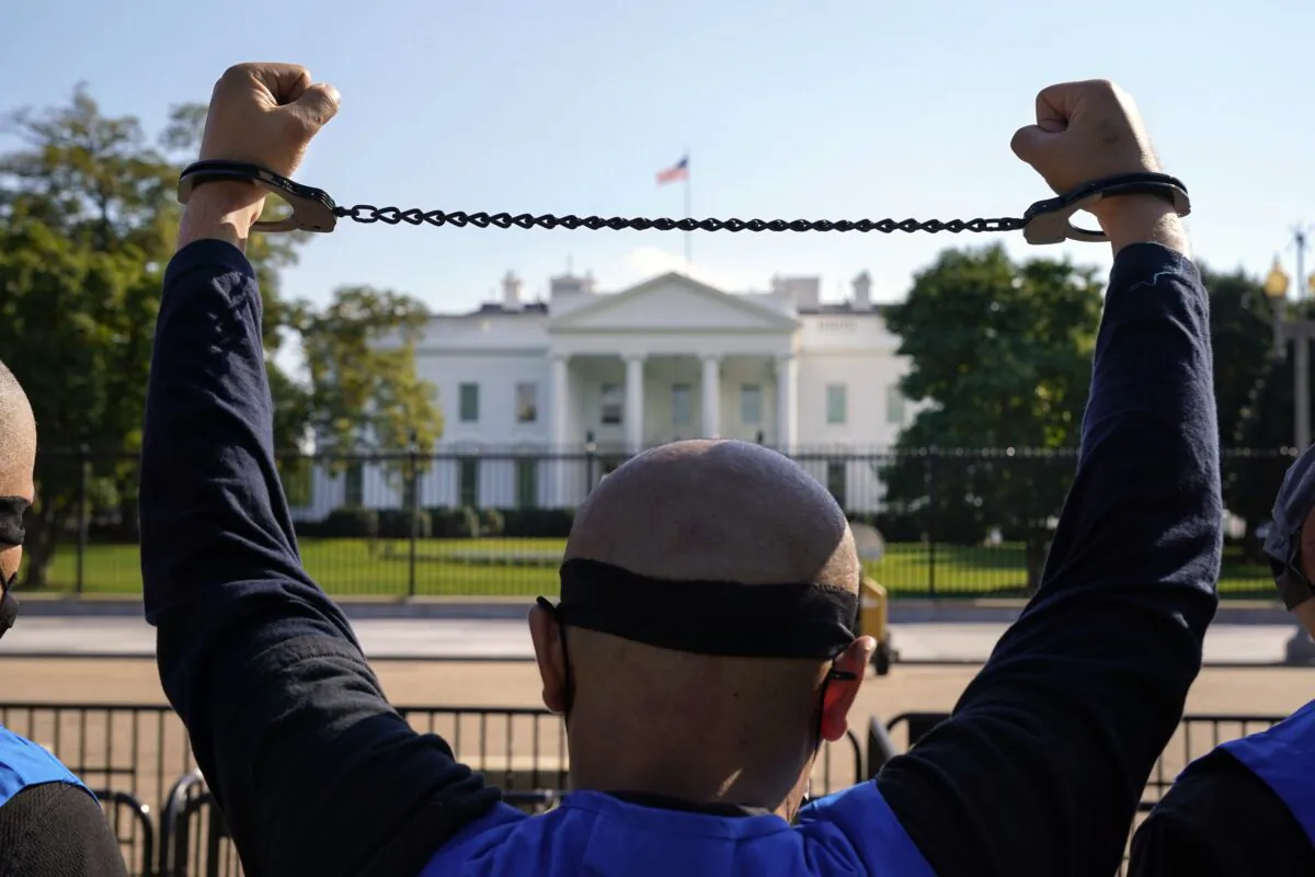 A member of the Uyghur American Association takes part in a rally in front of the White House on Oct. 1, 2020. (Jacquelyn Martin/AP Photo)