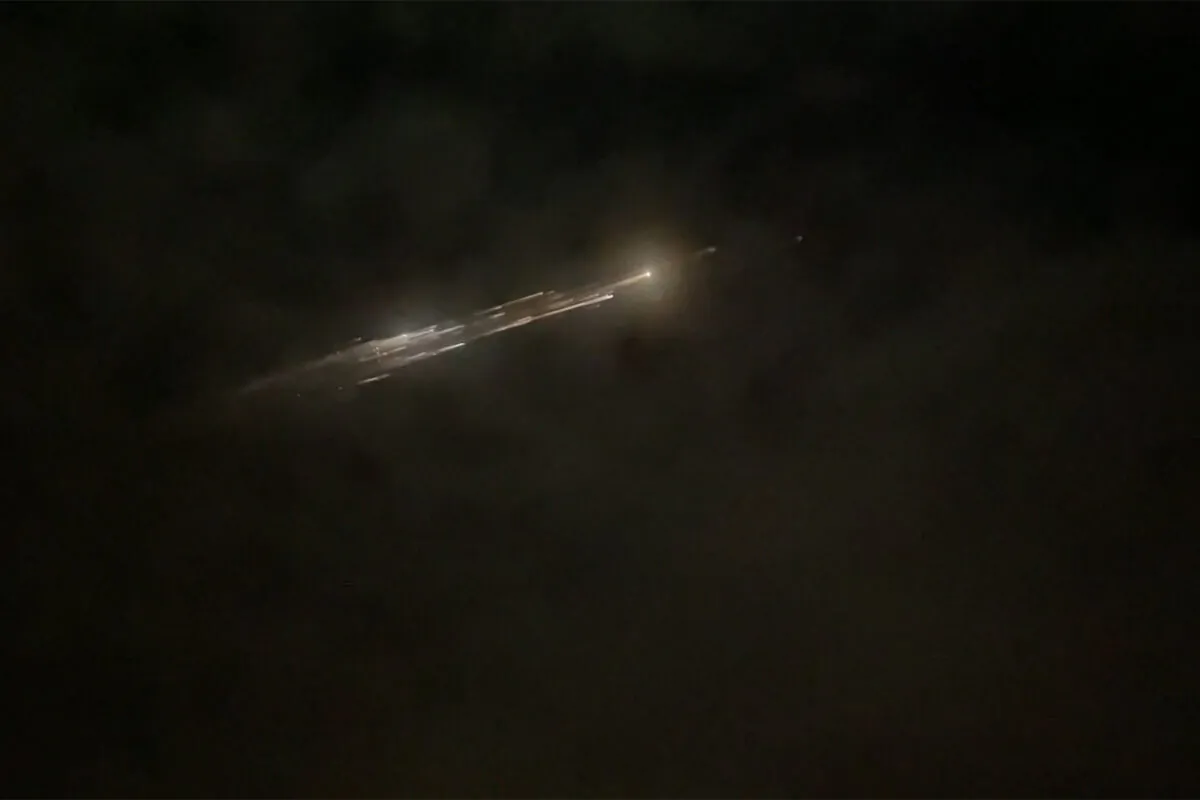 Debris from a SpaceX rocket lights up the sky behind clouds over Vancouver, Wash., on March 25, 2021. (Roman Puzhlyakov via AP)