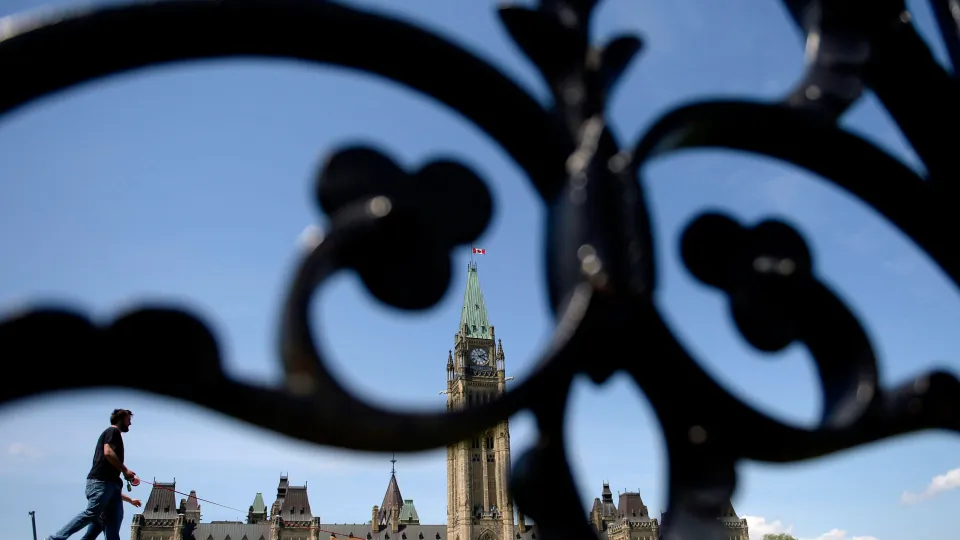 People walk on Parliament Hill on May 23, 2017. (Justin Tang/The Canadian Press)