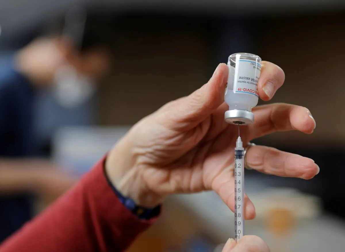A health worker prepares a syringe with a dose of the Moderna COVID-19 vaccine at a vaccination center in France. (Pascal Rossignol/File/Reuters)