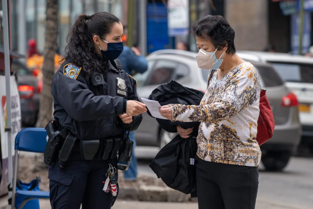 NYPD officers hand out information about hate crimes in Asian communities New York City, on March 17, 2021. (David Dee Delgado/Getty Images)