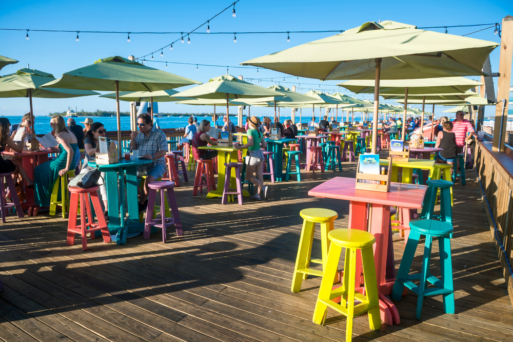 Visitors gather on colorful bar stools lining Sunset Pier at Mallory Square in Jan. 