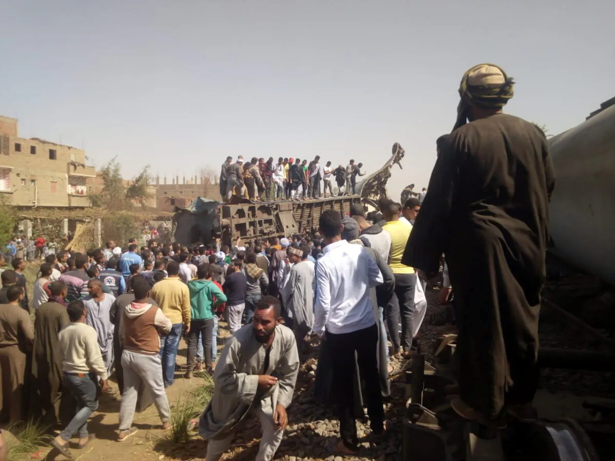 People inspect the damage after two trains have collided near the city of Sohag, Egypt, on March 26, 2021. (Stringer/Reuters)