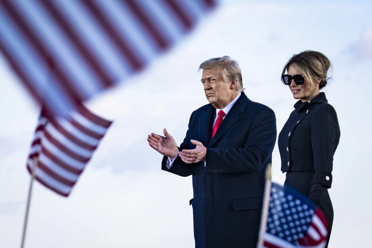 President Donald Trump and First Lady Melania Trump on stage after speaking to supporters at Joint Base Andrews before boarding Air Force One for his last time as president in Joint Base Andrews, Md., on Jan. 20, 2021. (Pete Marovich-Pool/Getty Images)