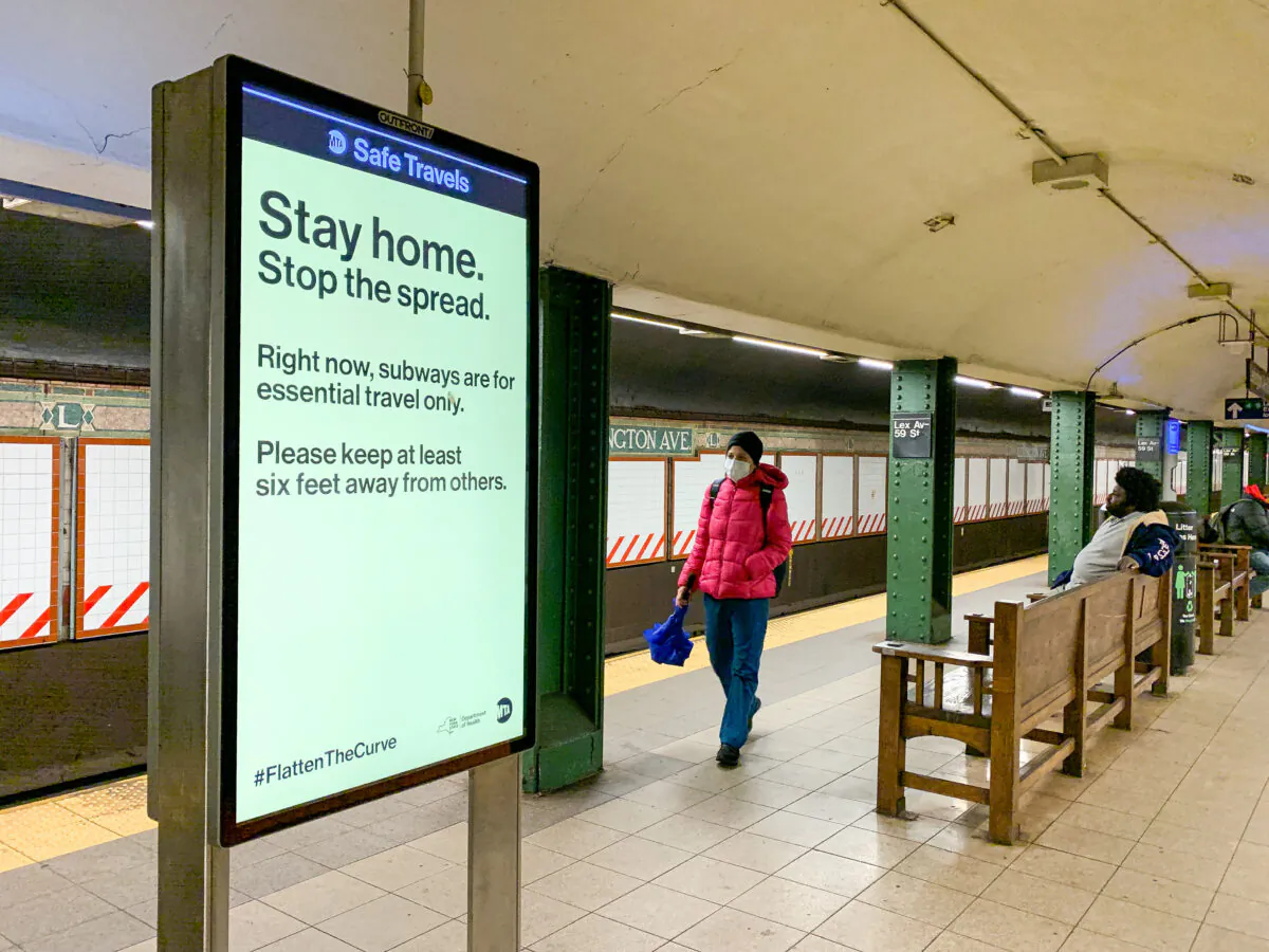 People in a subway station amid the COVID-19 pandemic, in New York City on March 29, 2020. (Chung I Ho/The Epoch Times)