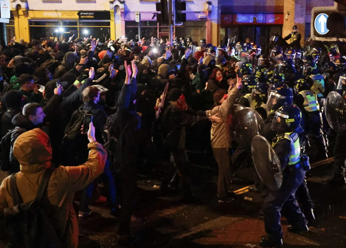 Police officers clash with demonstrators during a protest against a newly proposed policing bill, in Bristol, United Kingdom, on March 26, 2021. (Hannah McKay/Reuters)