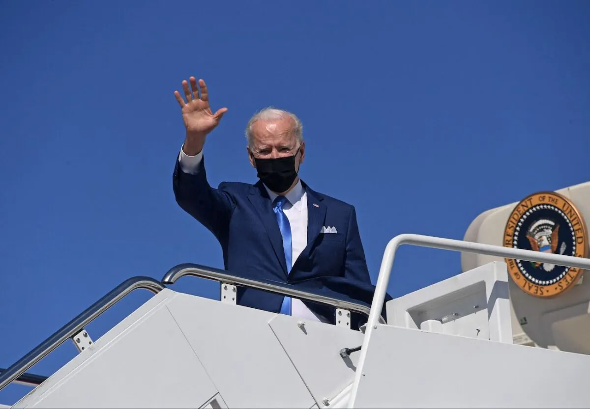 President Joe Biden waves as he boards Air Force One at Joint Base Andrews, Maryland, on March 26, 2021. (Olivier Douliery/AFP via Getty Images)