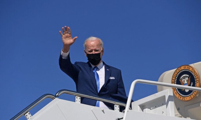 President Joe Biden waves as he boards Air Force One at Joint Base Andrews, Maryland, on March 26, 2021. (Olivier Douliery/AFP via Getty Images)