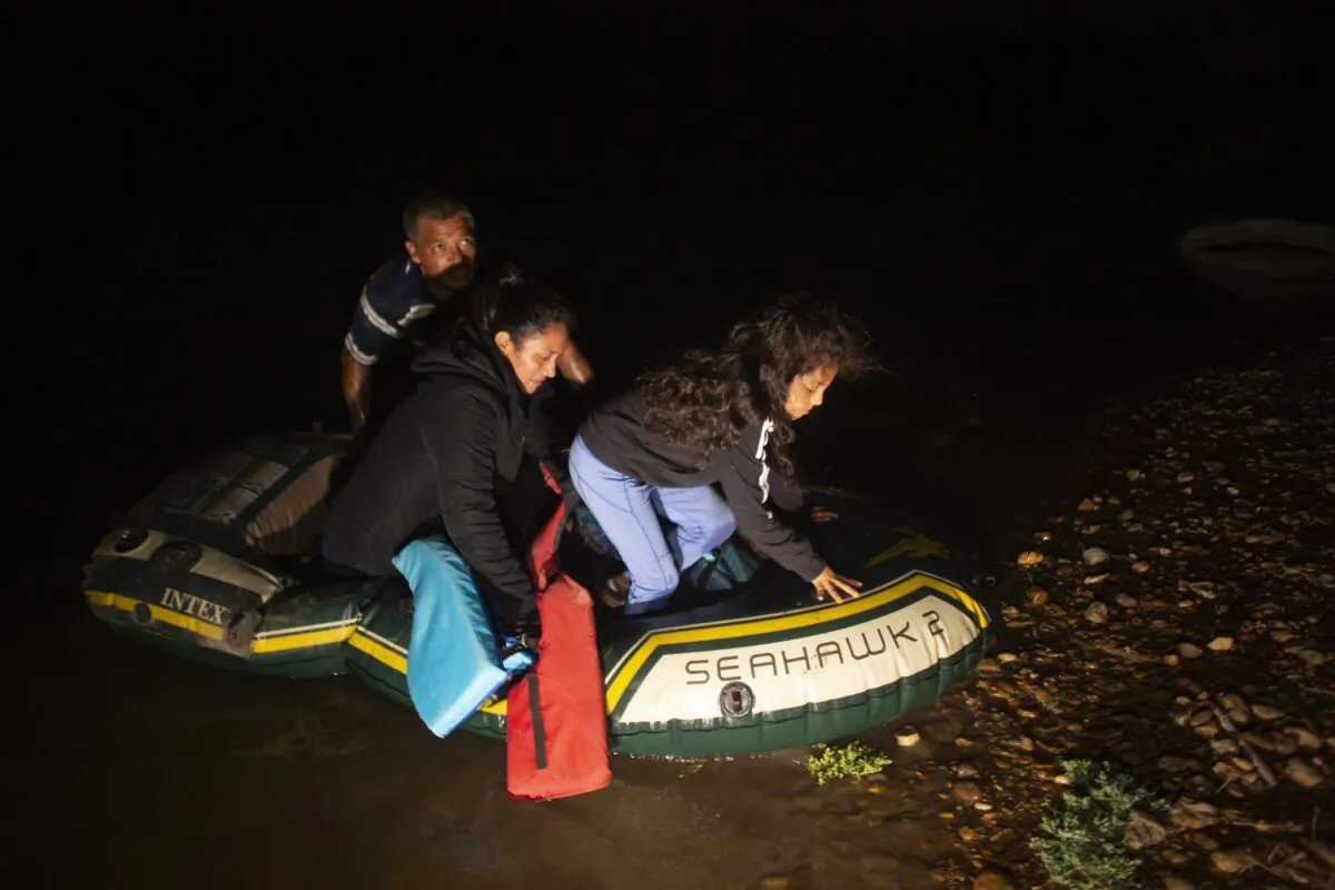 Kaylee Samantha, 7, who said she came alone from Mexico, gets off of a small inflatable raft onto U.S. soil after being delivered by a smuggler in Roma, Texas, on March 24, 2021. (Dario Lopez-Mills/AP Photo)