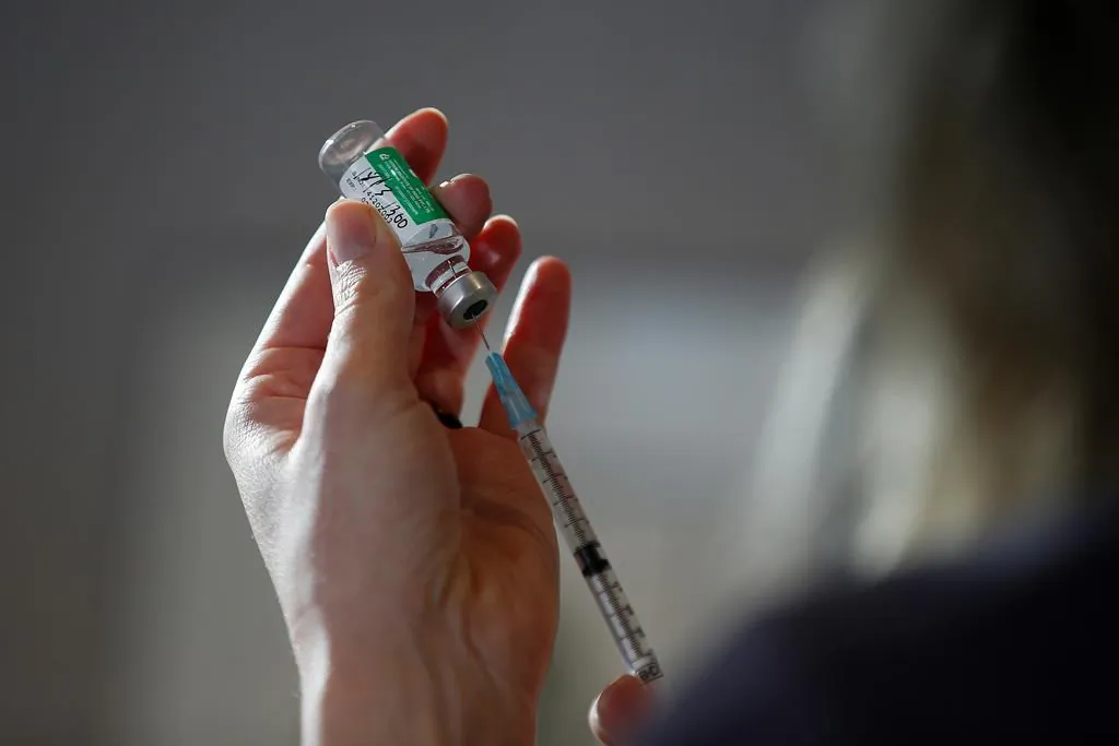 Dr. Joss Reimer, medical lead, Manitoba Vaccine Implementation Task Force draws a dose of the AstraZeneca COVID-19 vaccine at a clinic in Winnipeg, on March 19, 2021. (John Woods/The Canadian Press)