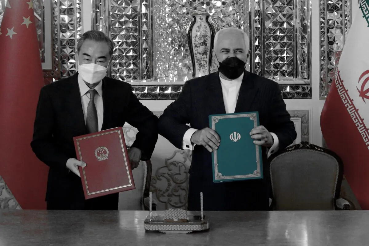 Iranian Foreign Minister Mohammad Javad Zarif (R) and his Chinese counterpart Wang Yi, pose for a picture after signing an agreement in Tehran, Iran, on March 27, 2021. (-/AFP via Getty Images)