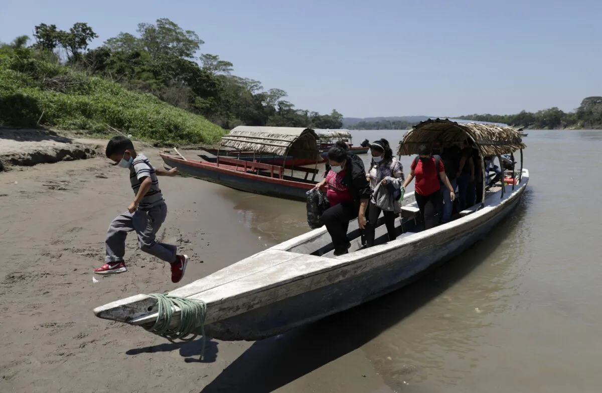 Migrants disembark on the Mexican side of the border after crossing the Usumacinta River from Guatemala, in Frontera Corozal, Chiapas state, Mexico, on March 24, 2021. (Eduardo Verdugo/AP Photo)