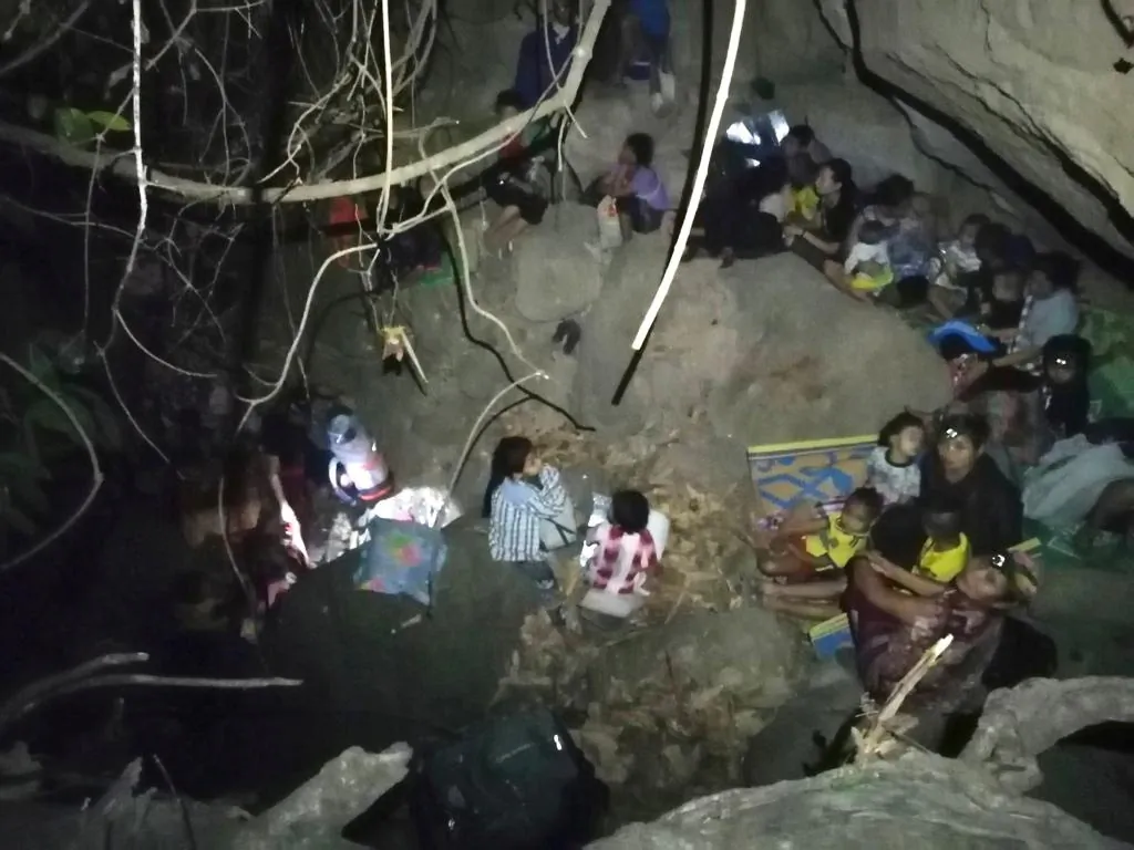 Ethnic Karen villagers displaced from Myanmar's Day Pu Noh village are seen in an unknown location in Karen state, after fleeing Burmese army air strikes, in this picture obtained from social media, Burma, on March 27, 2021. (Free Burma Rangers/via Reuters)