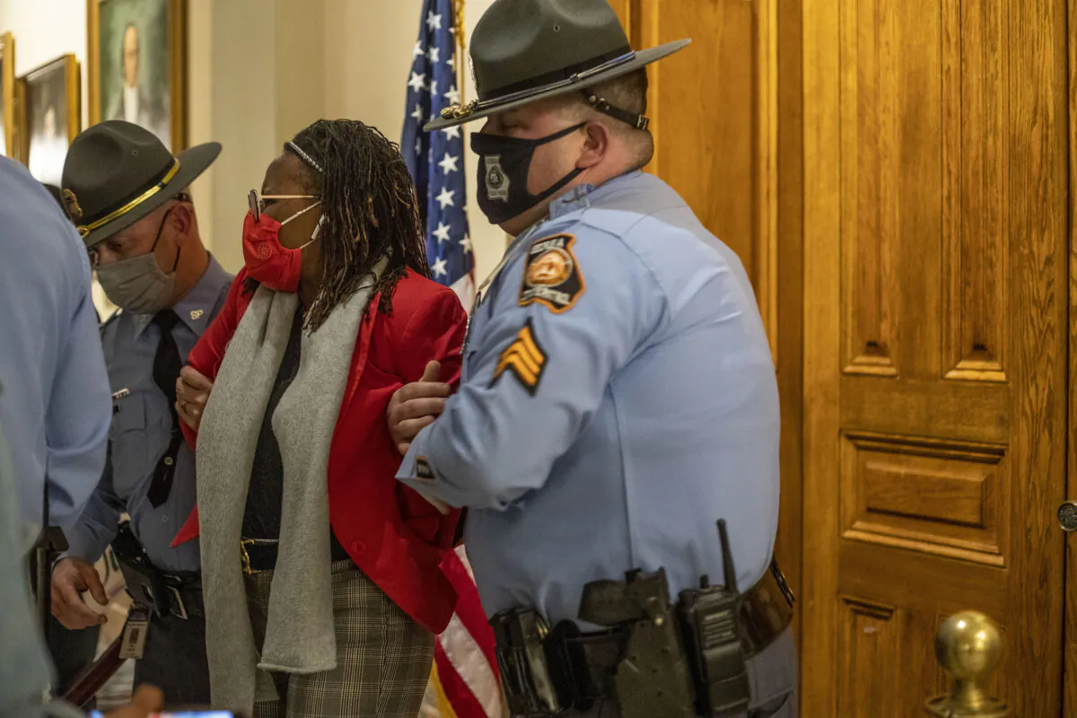 Georgia state Rep. Park Cannon (D-Atlanta) is placed in handcuffs by Georgia State Troopers after being asked to stop knocking on a door that led to Gov. Brian Kemp's office while Kemp was signing a voting restriction bill at the Georgia State Capitol Building in Atlanta on March 25, 2021. (Alyssa Pointer/Atlanta Journal-Constitution/TNS)