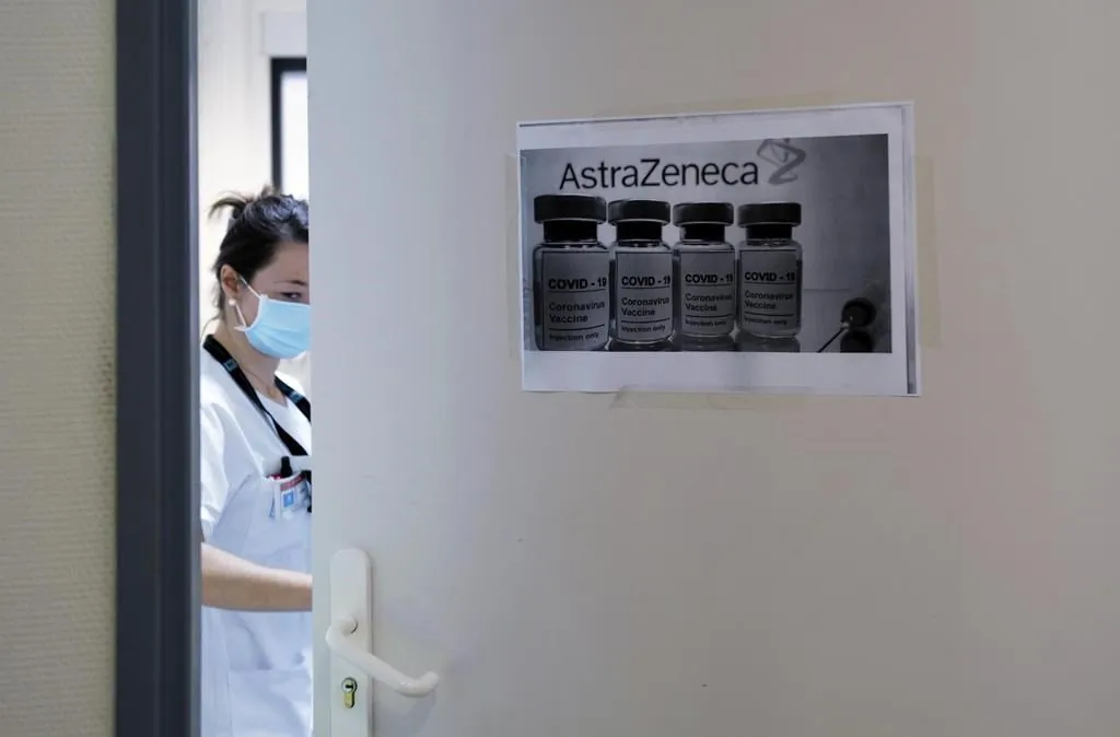 A health worker closes a door as she prepares doses of the AstraZeneca/Oxford vaccine at the Edouard Herriot hospital, on Feb. 6, 2021 in Lyon, central France. (Olivier Chassignole / Associated Press / File)