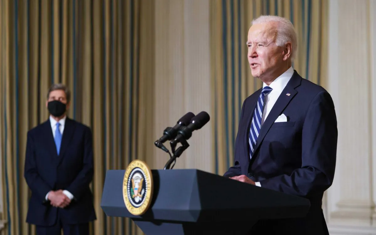 Special presidential envoy for climate John Kerry (L) listens to President Joe Biden speak on tackling climate change, creating jobs, and restoring scientific integrity at the White House in Washington on Jan. 27, 2021. (Mandel Ngan/AFP via Getty Images)