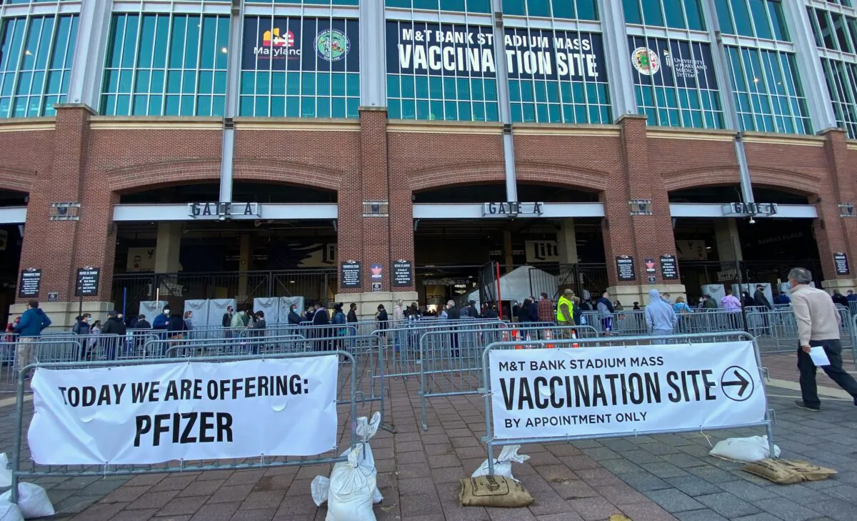 People line up at the a COVID-19 mass vaccination site at M&T Bank Stadium in Baltimore, on March 20, 2021. (Eric Baradat/AFP via Getty Images)