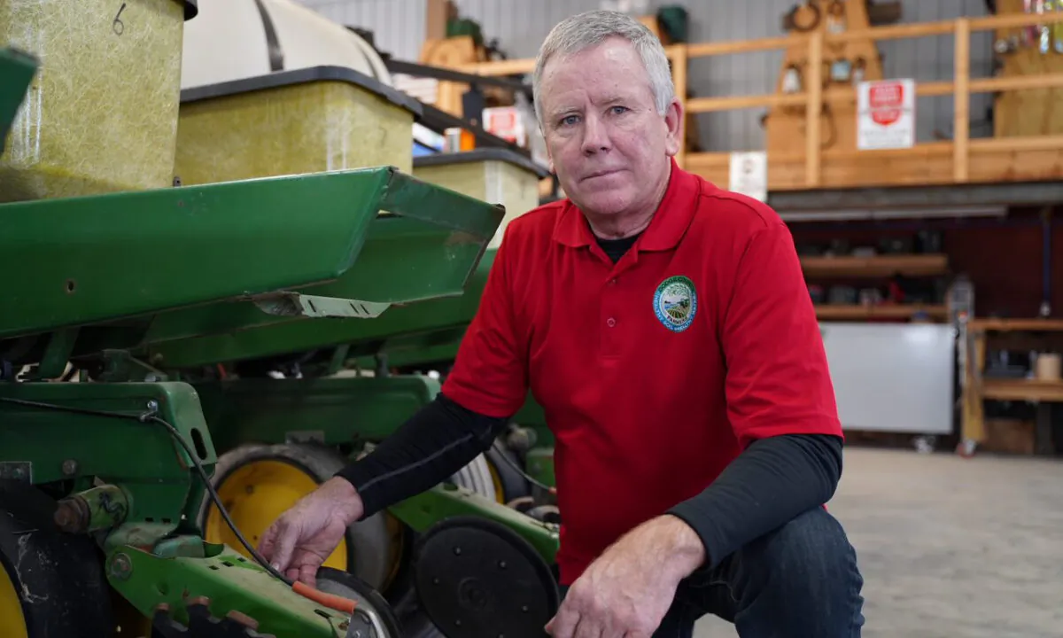 Farmer Tony Peirick shows a no-till planter at Tiger Farms in Neosho, Wis., on March 26, 2021. (Cara Ding/The Epoch Times) 