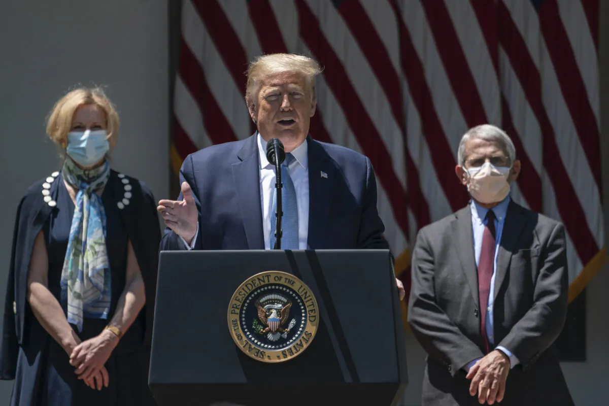 Flanked by White House coronavirus response coordinator Dr. Deborah Birx (L) and Dr. Anthony Fauci (R), director of the National Institute of Allergy and Infectious Diseases, U.S. President Donald Trump delivers remarks about coronavirus vaccine development in the Rose Garden of the White House in Washington on May 15, 2020. (Drew Angerer/Getty Images)