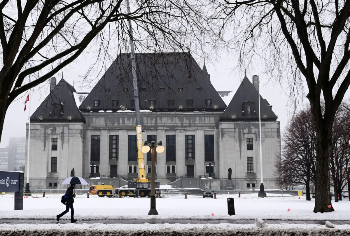 A pedestrian walks past the Supreme Court of Canada in Ottawa on Nov. 26, 2020. (The Canadian Press/Sean Kilpatrick)