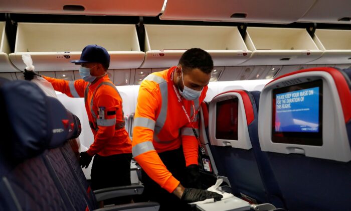 Delta Air Lines pre-flight cleaning crew members work on an aircraft at JFK International Airport, N.Y., on Aug. 6, 2020. (Shannon Stapleton/Reuters)