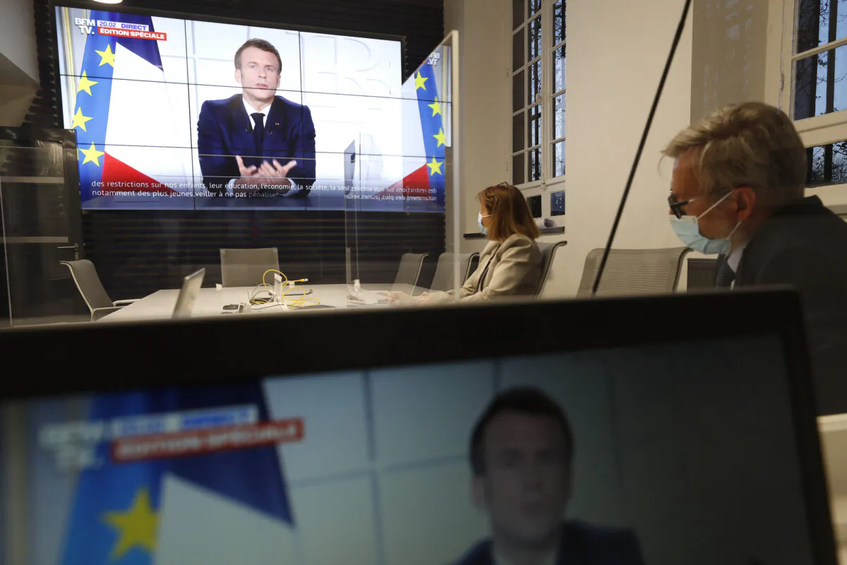 Local prefect Josiane Chevalier, second right, and her aide watch French President Emmanuel Macron addressing the nation, in the local government building in Strasbourg, eastern France, on March 31, 2021. (Jean-Francois Badias/AP Photo)