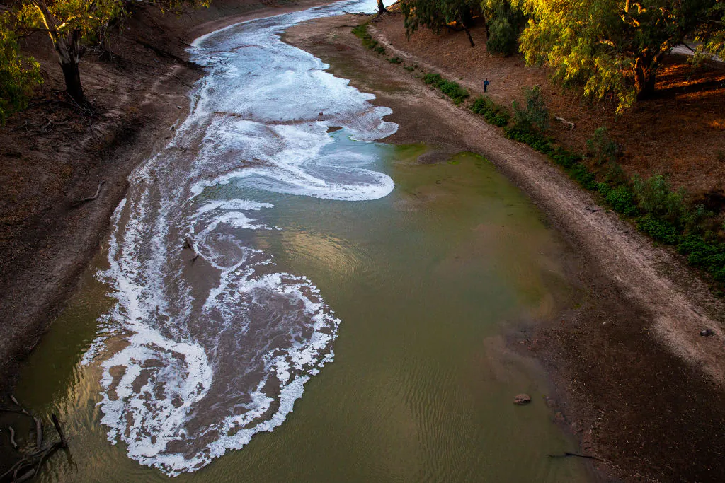 A new flow is seen meeting pools of green water along the Darling Barka river, as a flow of water arrives from upstream on February 24, 2020 in Louth, Australia. (Jenny Evans/Getty Images)