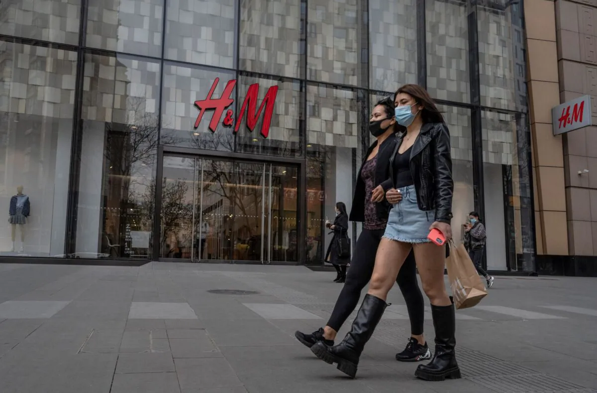 Women walk by an H&M clothing store in Beijing, China, on March 30, 2021. (Kevin Frayer/Getty Images)